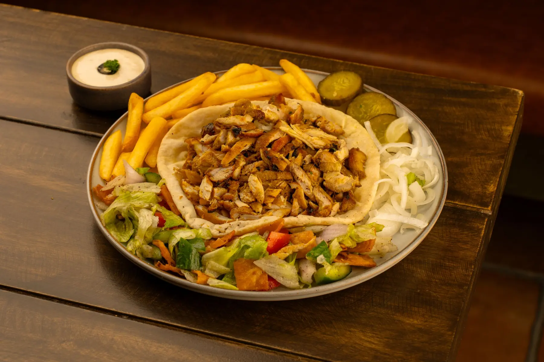 A shawarma plate with fries and salad